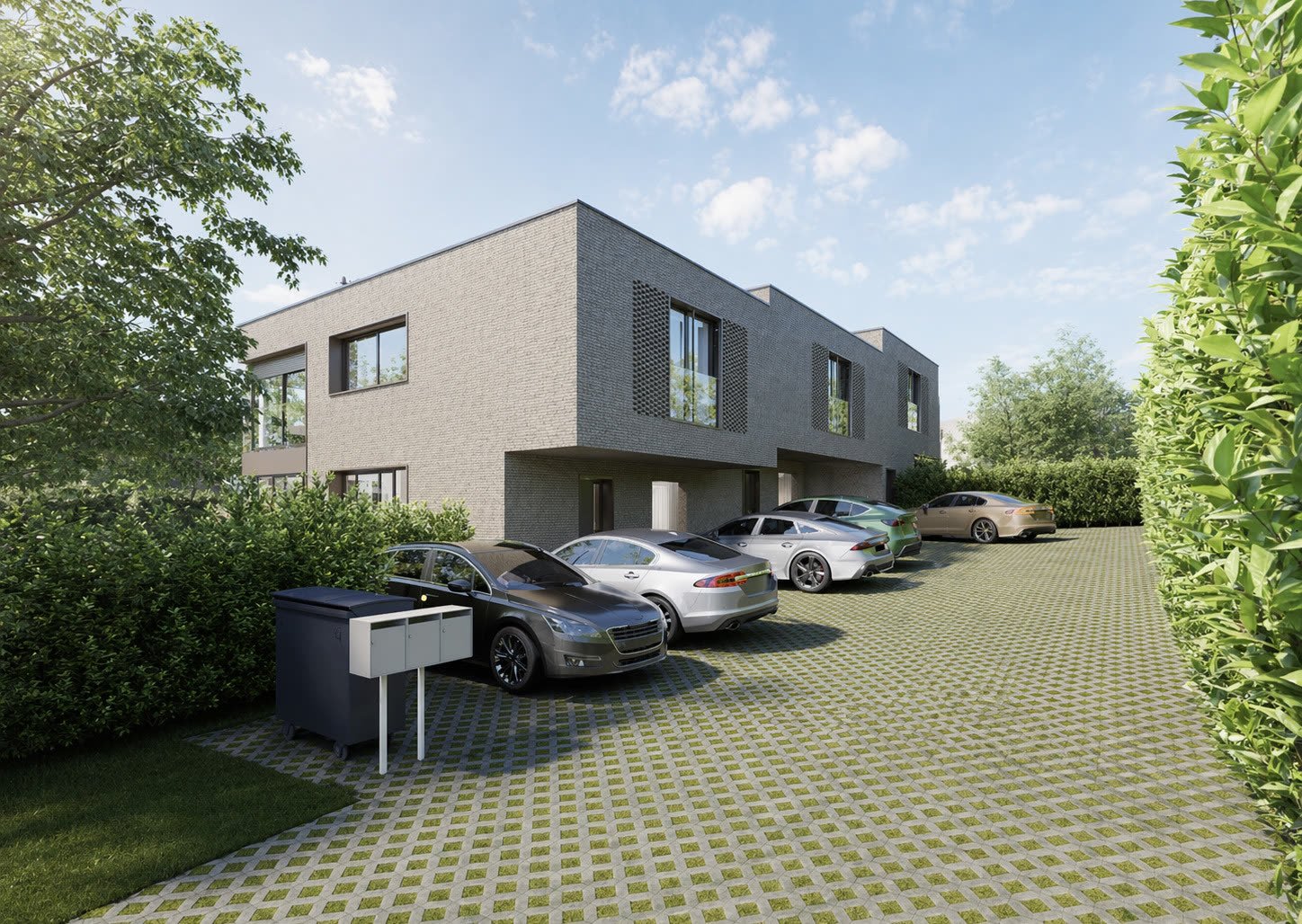 Façades des trois villas en briques claires, stationnement en pavés enherbés
